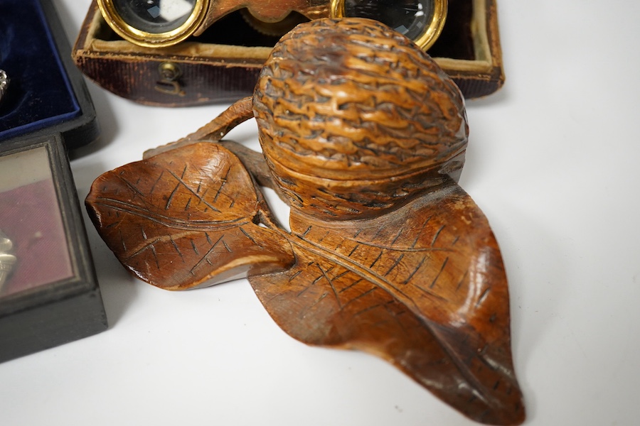 A pair of French opera glasses in case (a.f.), a wooden snuff-shoe, a carved wood walnut inkwell, a 